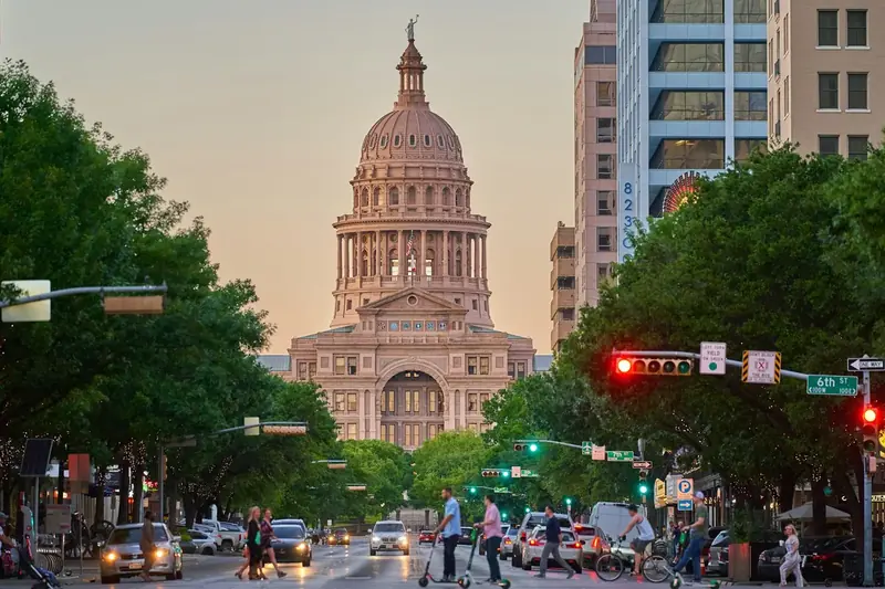 Texas State Capitol at dusk at the end of a downtown Austin street