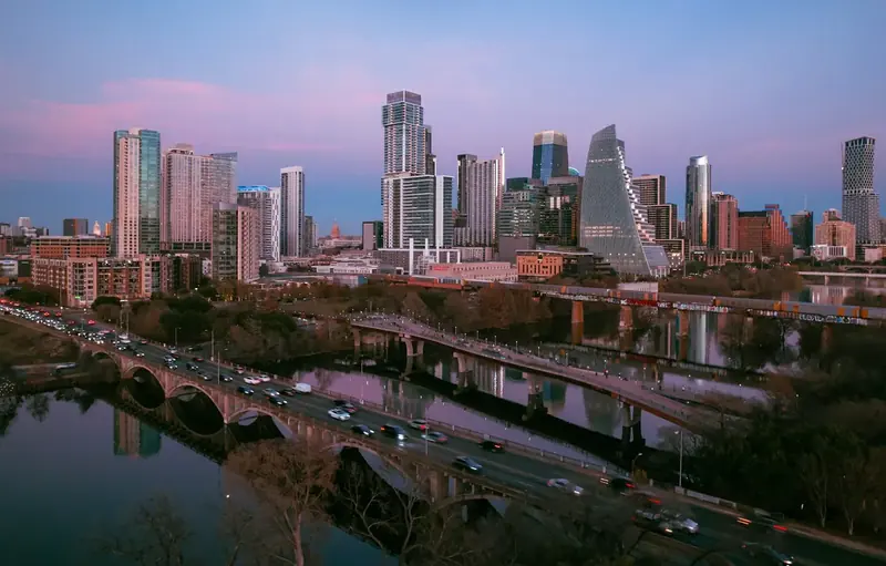 Austin skyline at dusk across bridges over the water