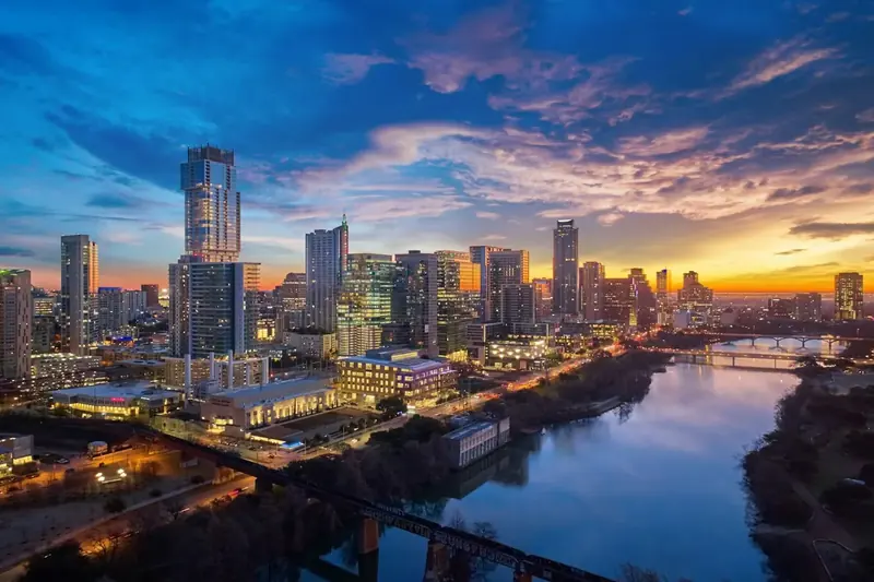 Downtown Austin skyline at sunset with the river in the foreground